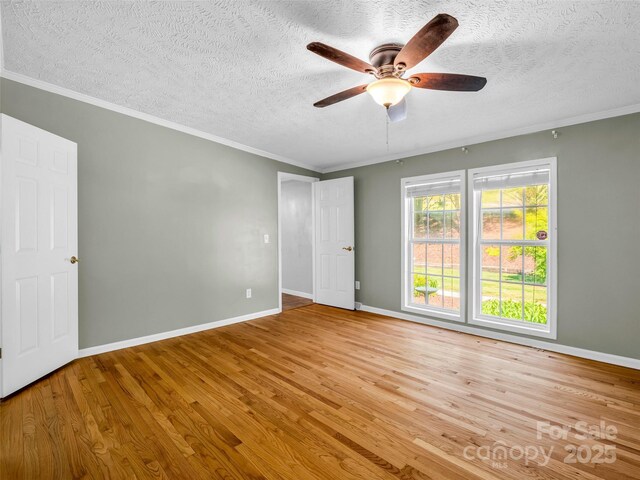 2941 Nix Creek Rd, Marion, NC 28752 - unfurnished room featuring wood finished floors, a textured ceiling, a ceiling fan, baseboards, and ornamental molding