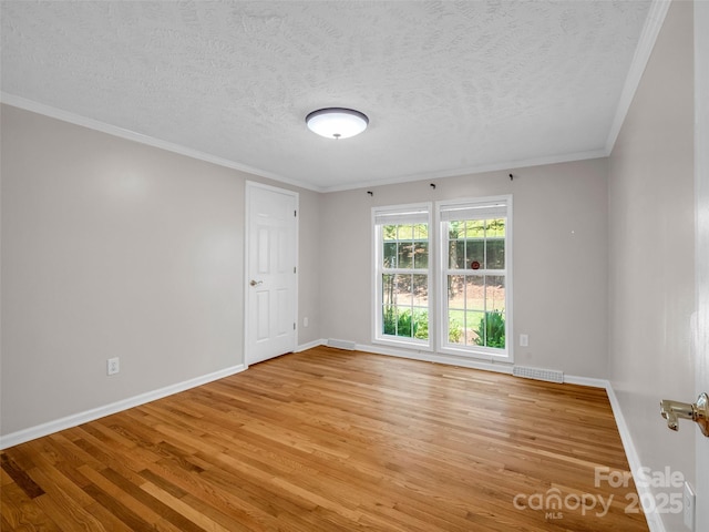 2941 Nix Creek Rd, Marion, NC 28752 - spare room featuring light wood finished floors, a textured ceiling, baseboards, and crown molding