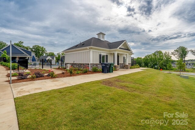 154 Stella Ln Unit A, Troutman, NC 28166 - view of side of property featuring board and batten siding, stone siding, a shingled roof, and a chimney
