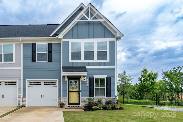 154 Stella Ln Unit A, Troutman, NC 28166 - craftsman-style house featuring board and batten siding, driveway, an attached garage, a front lawn, and roof with shingles