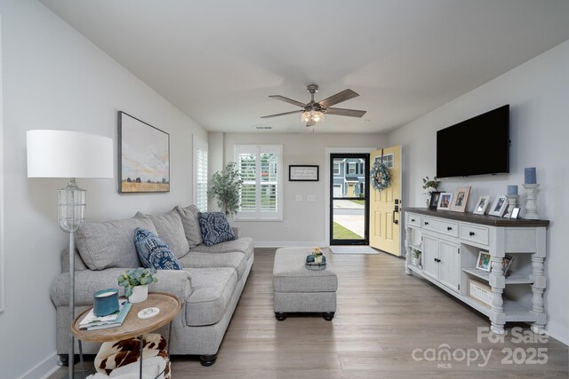 154 Stella Ln Unit A, Troutman, NC 28166 - living room featuring wood finished floors and a ceiling fan