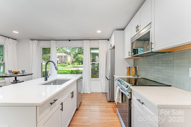 4014 Sulkirk Rd, Charlotte, NC 28210 - kitchen featuring stainless steel appliances, plenty of natural light, light countertops, light wood-style flooring, and recessed lighting