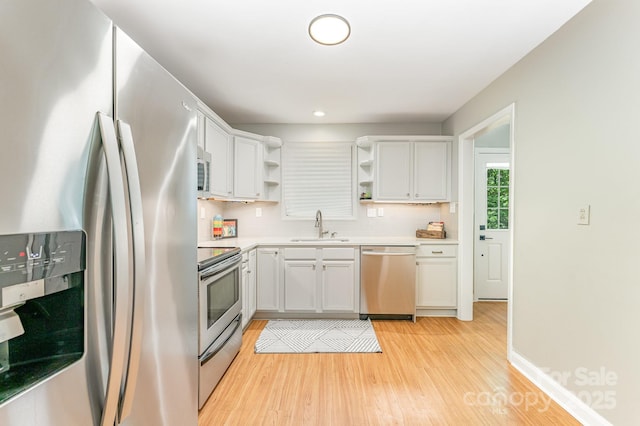 4014 Sulkirk Rd, Charlotte, NC 28210 - kitchen featuring stainless steel appliances, open shelves, light wood-style floors, light countertops, and white cabinets