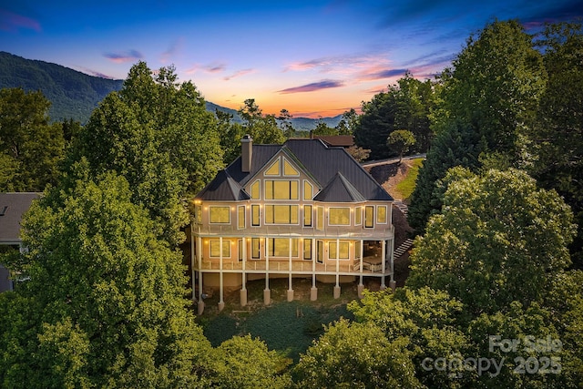 122 Eagles Crest Way, Lake Lure, NC 28746 - rear view of property featuring a balcony, a chimney, a metal roof, a standing seam roof, and a mountain view