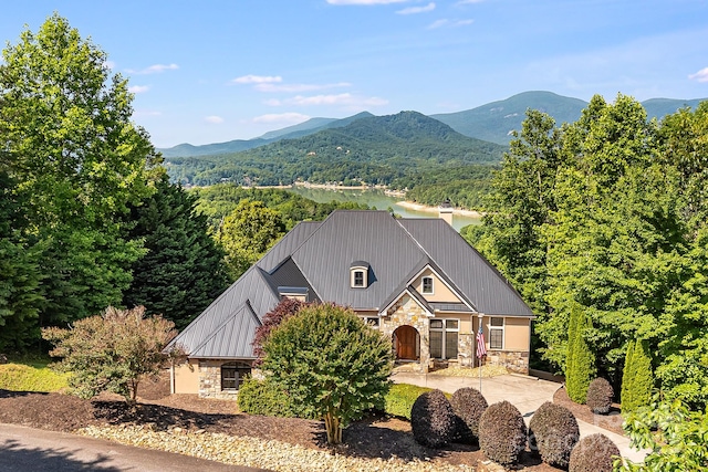 122 Eagles Crest Way, Lake Lure, NC 28746 - view of front of home with stone siding, a mountain view, a metal roof, and a wooded view
