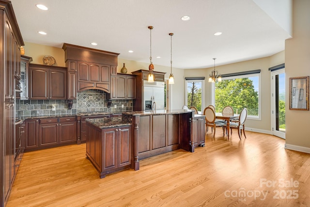 122 Eagles Crest Way, Lake Lure, NC 28746 - kitchen featuring stainless steel appliances, a center island, light wood-style flooring, decorative backsplash, and recessed lighting