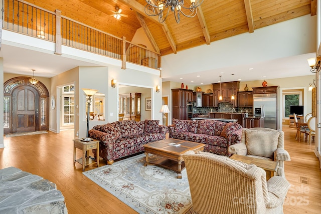 122 Eagles Crest Way, Lake Lure, NC 28746 - living area featuring a chandelier, a wood ceiling with exposed beams, high vaulted ceiling, and light wood-style floors