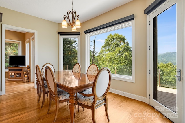 122 Eagles Crest Way, Lake Lure, NC 28746 - dining area featuring a chandelier, light wood-style flooring, and plenty of natural light