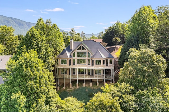 122 Eagles Crest Way, Lake Lure, NC 28746 - back of house with a balcony, a chimney, a standing seam roof, a metal roof, and a mountain view