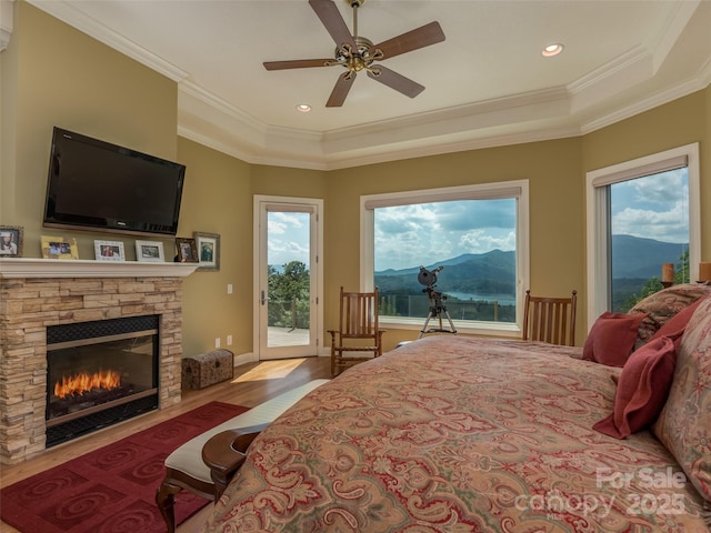 122 Eagles Crest Way, Lake Lure, NC 28746 - bedroom with access to outside, wood finished floors, crown molding, a fireplace, and a mountain view