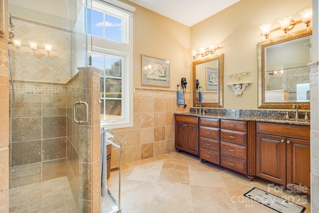 122 Eagles Crest Way, Lake Lure, NC 28746 - full bath featuring tile walls, double vanity, a stall shower, wainscoting, and tile patterned floors