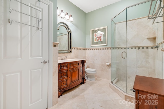 122 Eagles Crest Way, Lake Lure, NC 28746 - full bathroom with vanity, tile walls, a stall shower, tile patterned floors, and a wainscoted wall