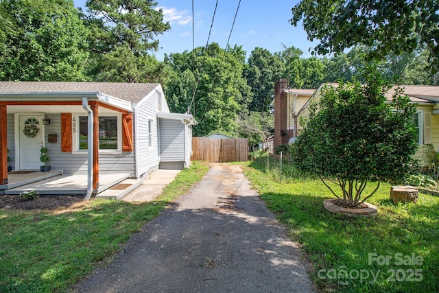 405 E 18th St, Kannapolis, NC 28083 - view of property exterior featuring asphalt driveway, a porch, and roof with shingles