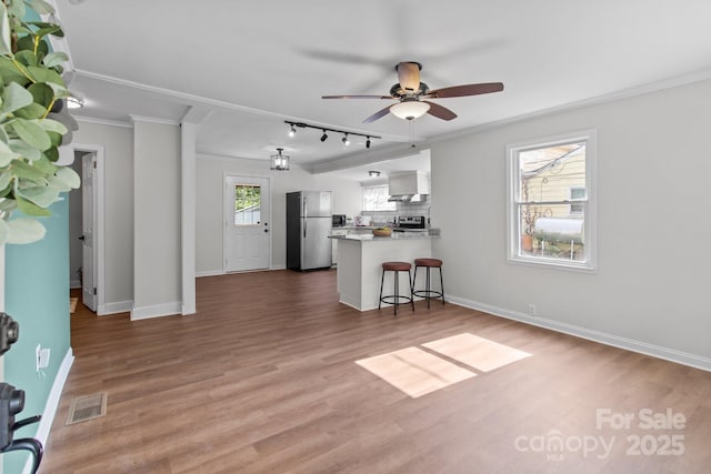 405 E 18th St, Kannapolis, NC 28083 - living room with ceiling fan, wood finished floors, and ornamental molding