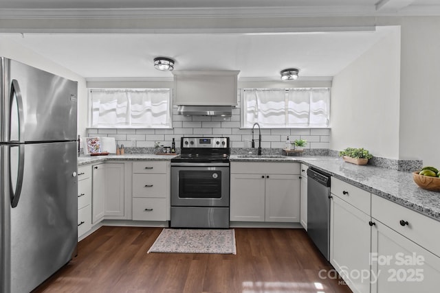 405 E 18th St, Kannapolis, NC 28083 - kitchen with appliances with stainless steel finishes, exhaust hood, dark wood finished floors, and decorative backsplash
