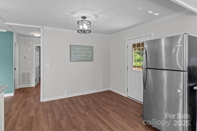 405 E 18th St, Kannapolis, NC 28083 - unfurnished dining area featuring dark wood-style floors and crown molding
