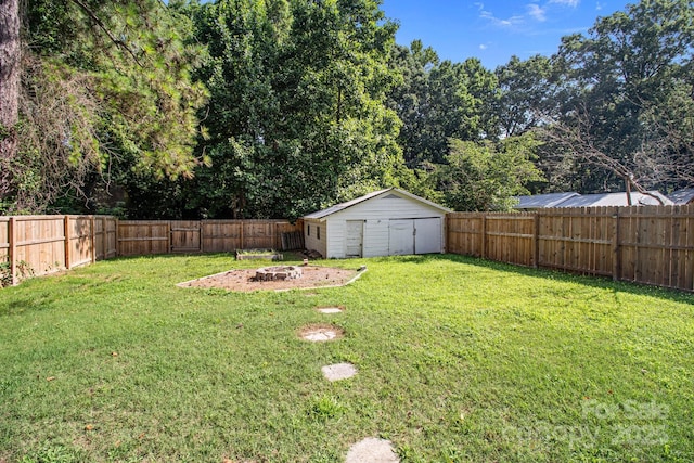 405 E 18th St, Kannapolis, NC 28083 - fenced backyard with an outdoor fire pit and a storage unit