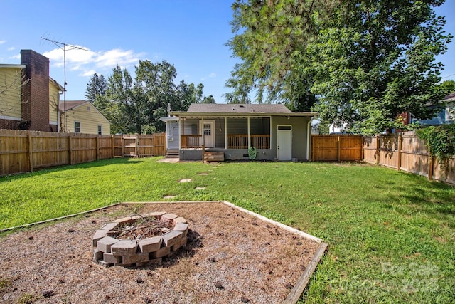 405 E 18th St, Kannapolis, NC 28083 - rear view of house with a fenced backyard, an outdoor fire pit, and covered porch