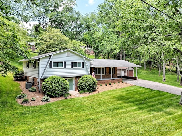 110 Stoney Brook Dr, Clyde, NC 28721 - split level home with driveway, a front yard, brick siding, cooling unit, and view of scattered trees