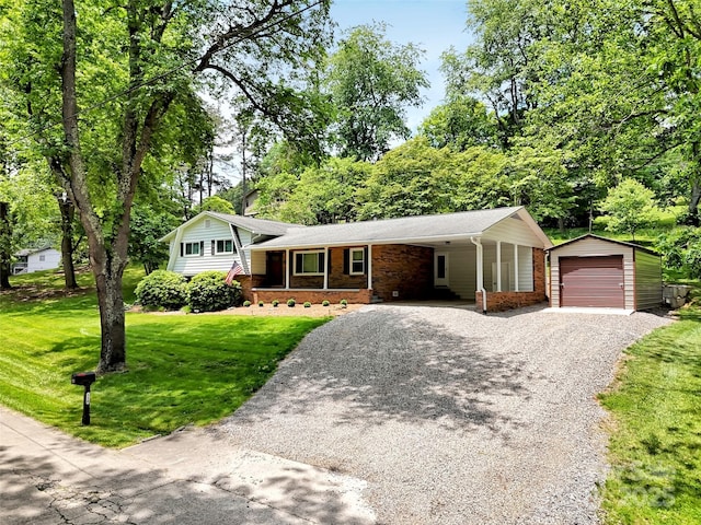 110 Stoney Brook Dr, Clyde, NC 28721 - tri-level home with gravel driveway, an outbuilding, a front yard, a detached garage, and a carport