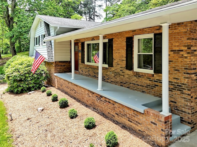 110 Stoney Brook Dr, Clyde, NC 28721 - view of side of home with a porch and brick siding