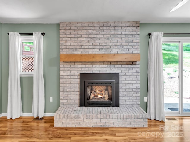 110 Stoney Brook Dr, Clyde, NC 28721 - detailed view of wood finished floors, a brick fireplace, and baseboards