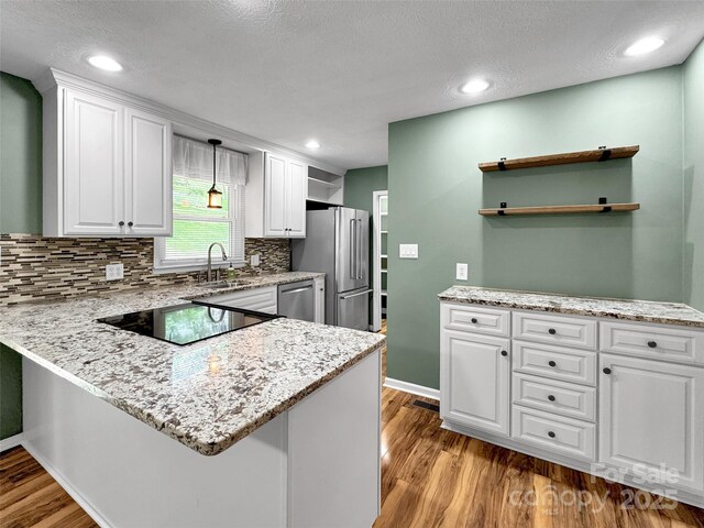 110 Stoney Brook Dr, Clyde, NC 28721 - kitchen with appliances with stainless steel finishes, open shelves, white cabinetry, a peninsula, and recessed lighting