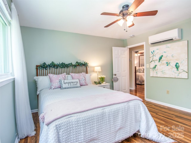110 Stoney Brook Dr, Clyde, NC 28721 - bedroom with a wall mounted AC, baseboards, wood finished floors, and a ceiling fan