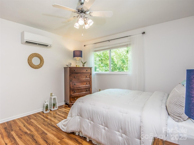 110 Stoney Brook Dr, Clyde, NC 28721 - bedroom with an AC wall unit, wood finished floors, baseboards, and ceiling fan