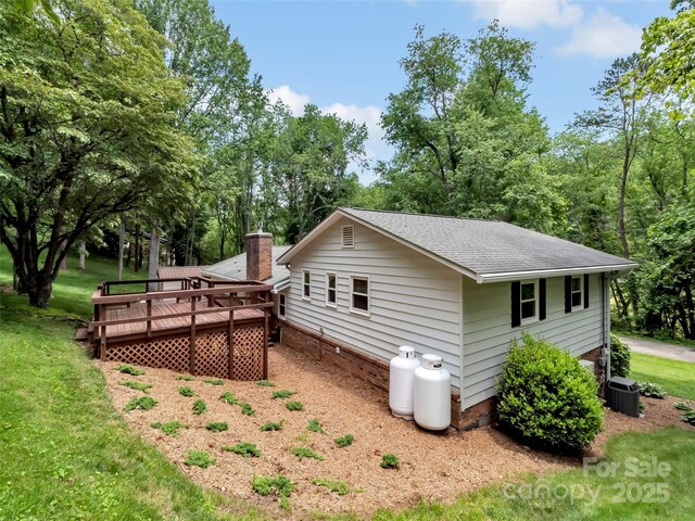 110 Stoney Brook Dr, Clyde, NC 28721 - view of side of home featuring a deck, a shingled roof, a lawn, and central AC unit