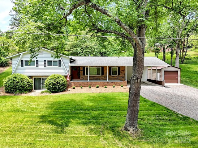 110 Stoney Brook Dr, Clyde, NC 28721 - tri-level home with a front yard, driveway, an outdoor structure, a garage, and a porch