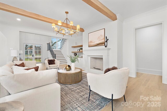 1321 Ferncliff Rd, Charlotte, NC 28211 - living room featuring beam ceiling, light wood-style floors, stairs, crown molding, and a chandelier