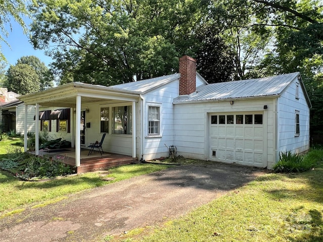 511 Westview St SW, Lenoir, NC 28645 - ranch-style house featuring a chimney, a garage, asphalt driveway, covered porch, and metal roof