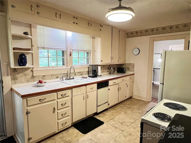 511 Westview St SW, Lenoir, NC 28645 - kitchen with white appliances, a sink, tile counters, and decorative backsplash