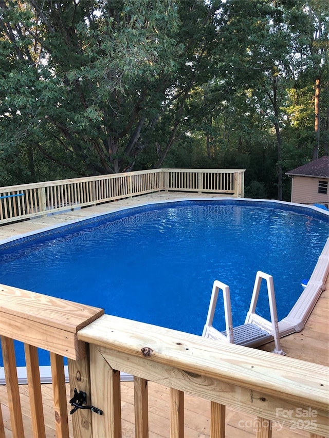 106 Condover Pl, Charlotte, NC 28270 - swimming pool featuring view of scattered trees and a deck