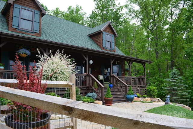394 Hummingbird Ln, Elk Park, NC 28622 - view of front of home featuring covered porch, a shingled roof, and stairway
