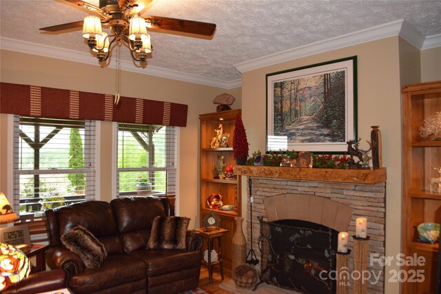 394 Hummingbird Ln, Elk Park, NC 28622 - living room with a ceiling fan, a textured ceiling, crown molding, and a fireplace