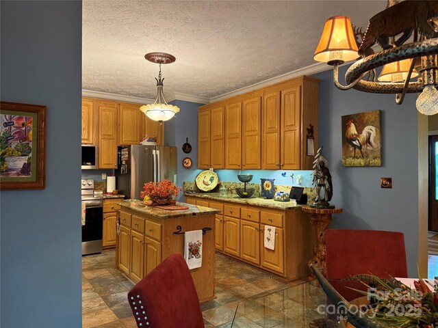 394 Hummingbird Ln, Elk Park, NC 28622 - kitchen featuring stainless steel appliances, ornamental molding, a kitchen island, decorative light fixtures, and a textured ceiling