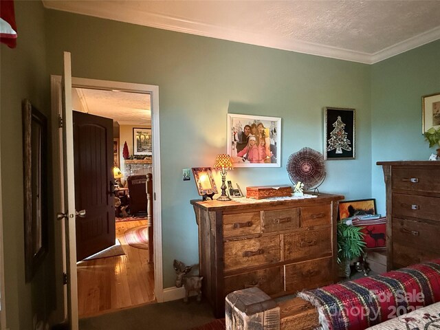 394 Hummingbird Ln, Elk Park, NC 28622 - bedroom with ornamental molding, wood finished floors, and a textured ceiling