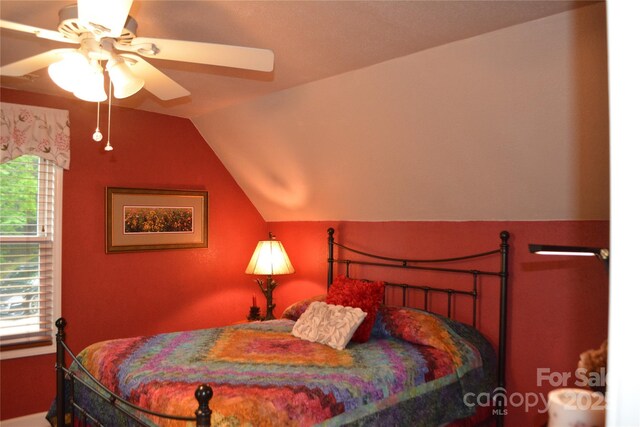 394 Hummingbird Ln, Elk Park, NC 28622 - bedroom with multiple windows, vaulted ceiling, and a ceiling fan