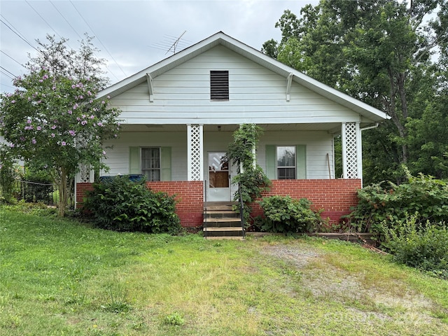 28 Central Ave, Granite Falls, NC 28630 - bungalow-style home with covered porch, brick siding, and a front yard