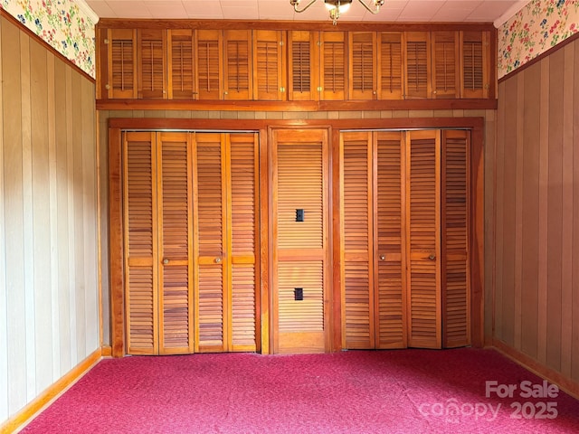 28 Central Ave, Granite Falls, NC 28630 - detailed view of wood walls, carpet floors, wallpapered walls, and a chandelier