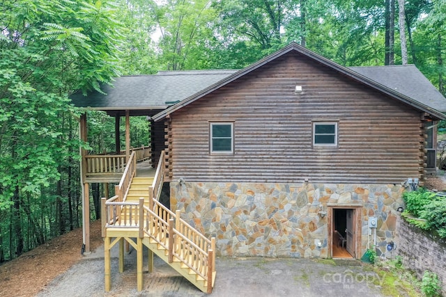 184 Sunlight Path, Lake Lure, NC 28746 - back of house featuring log siding, stairs, stone siding, and a shingled roof