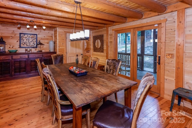 184 Sunlight Path, Lake Lure, NC 28746 - dining area with light wood-style flooring, a wooden ceiling with exposed beams, and wooden walls