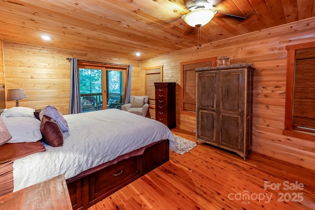 184 Sunlight Path, Lake Lure, NC 28746 - bedroom with wood walls, light wood-style floors, wood ceiling, access to exterior, and two closets