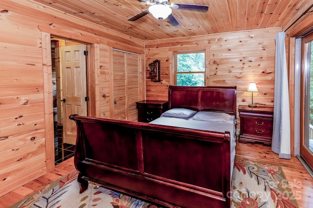 184 Sunlight Path, Lake Lure, NC 28746 - bedroom with light wood finished floors, wooden ceiling, multiple windows, wood walls, and ceiling fan