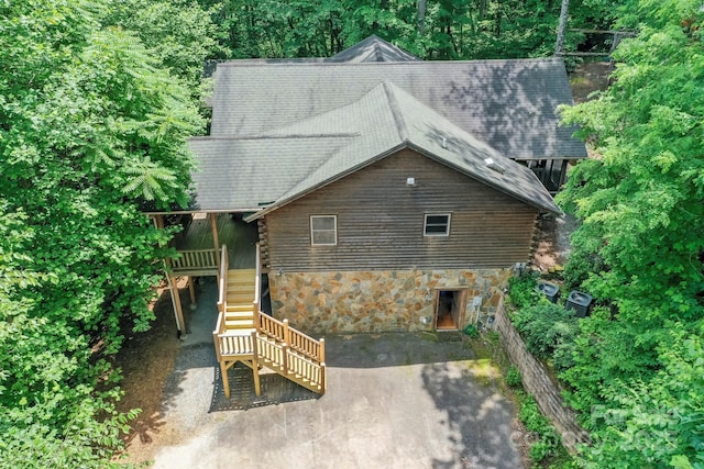 184 Sunlight Path, Lake Lure, NC 28746 - view of front facade featuring stairway, stone siding, log siding, a patio, and a shingled roof