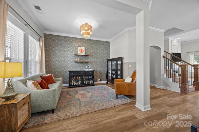 11329 Fullerton Place Dr NW, Huntersville, NC 28078 - living area featuring crown molding, stairway, wood finished floors, and arched walkways
