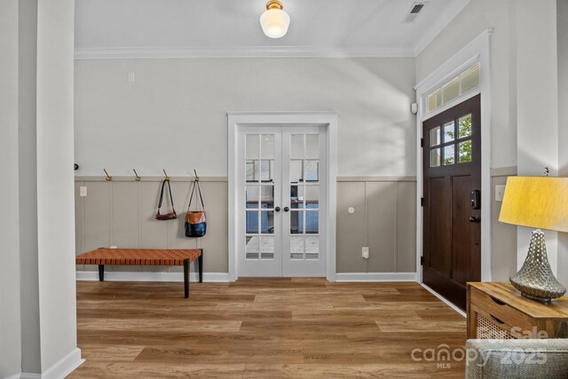 11329 Fullerton Place Dr NW, Huntersville, NC 28078 - entrance foyer with french doors, crown molding, wood finished floors, and a wainscoted wall