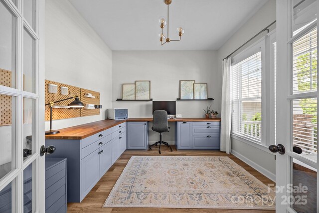 11329 Fullerton Place Dr NW, Huntersville, NC 28078 - office with built in study area, light wood-style flooring, healthy amount of natural light, and a chandelier